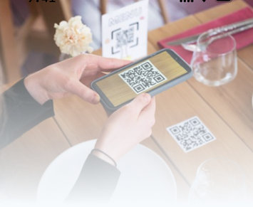 Person scanning a QR code at a restaurant table